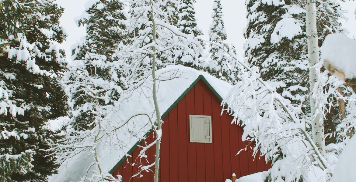 Snow-covered wooden house in winter